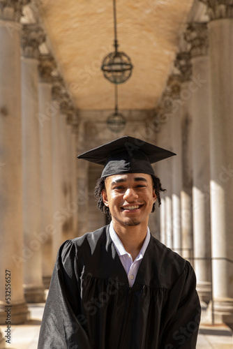 Portrait Handsome happy black college graduate and  mortarboard  photo