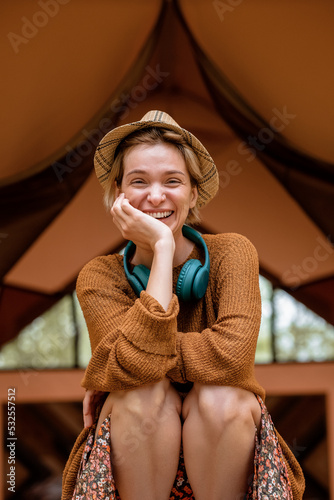 Happy tourist laughing outside tent