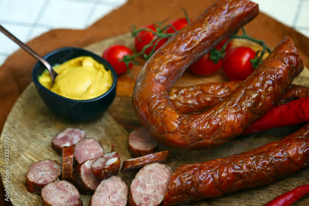 Chopped smoked sausages. Fresh homemade sausages on a wooden board. Chopped smoked sausages. Fresh homemade sausages on a wooden board.