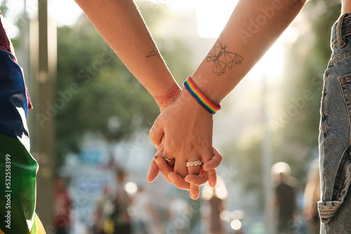 Anonymous lesbian couple holding hands at pride