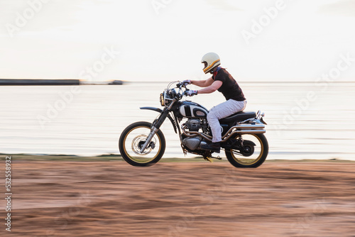 Rider ride a motorcycle fast on the beach