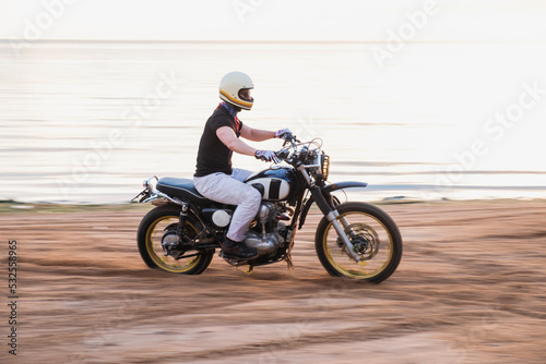Rider ride a motorcycle fast on the beach photo