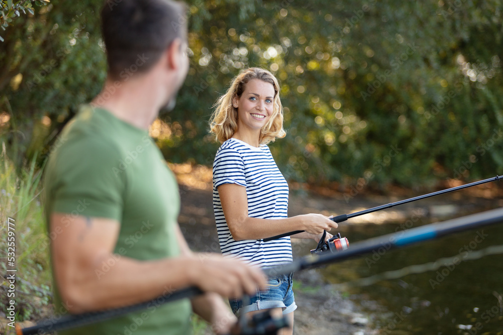 beautiful couple catching fish in the pond beautiful couple catching fish in the pond