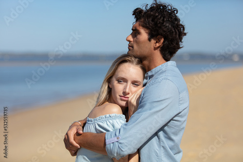 a young couple enjoying a solitary beach backriding