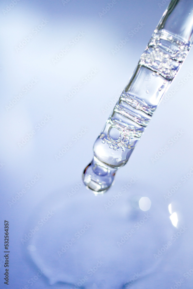 Transparent facial serum pipette on blue background. Soft focus. Cosmetic Beauty product closeup. Transparent facial serum pipette on blue background. Soft focus. Cosmetic Beauty product closeup.