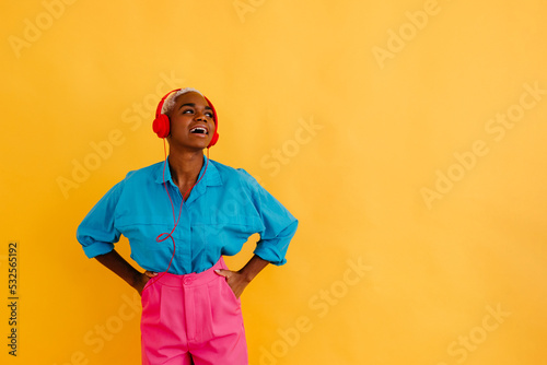 Joyful black woman listening to song in studio
