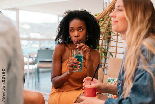 Black woman listening and drinking