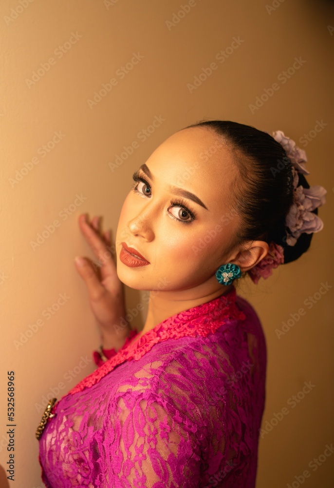 Balinese bride wearing the pink wedding dress before the ceremony has