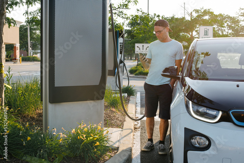 Man charging his electric car
