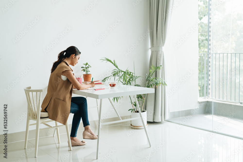 Pretty student studying at table indoors Pretty student studying at table indoors