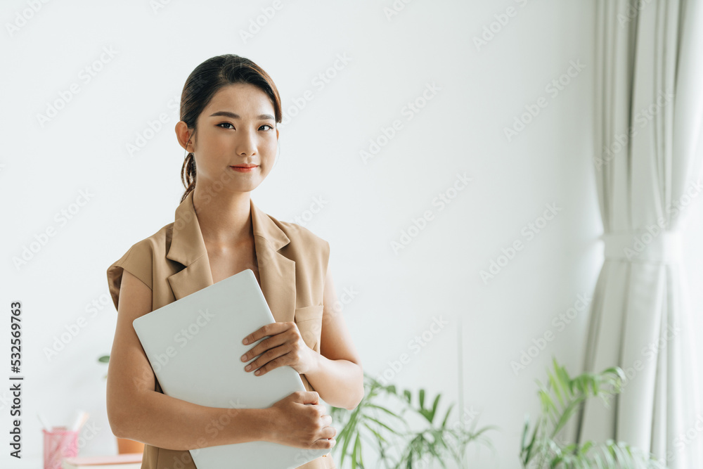 Professional asian female manager standing in office and holding Professional asian female manager standing in office and holding