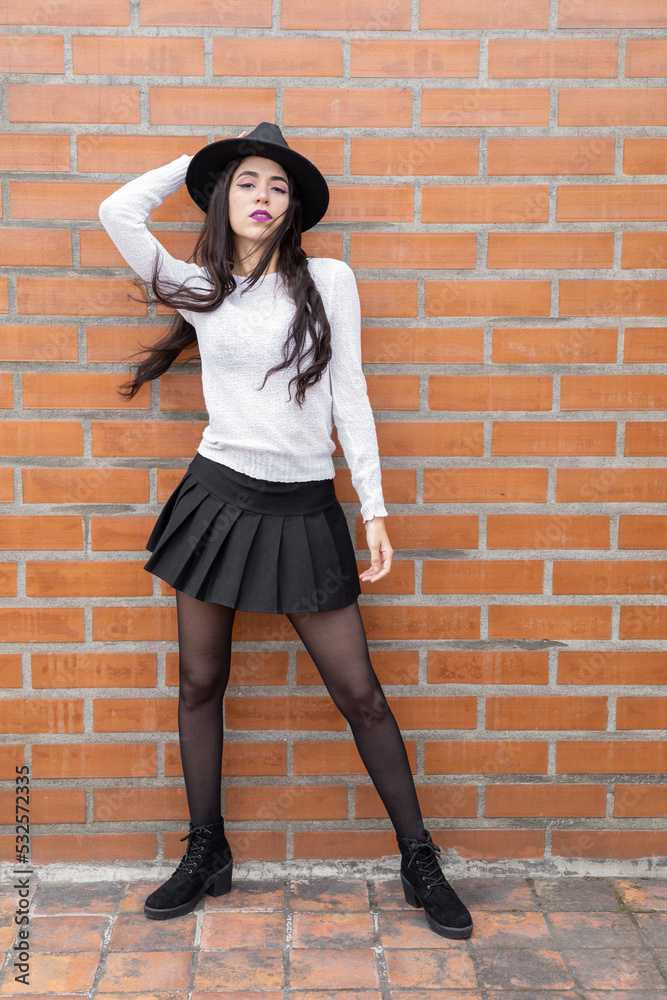 beautiful and glamorous slim female model with long hair, wears a skirt, sweater, leggings and hat, fashion and beauty, latin woman posing beautiful and glamorous slim female model with long hair, wears a skirt, sweater, leggings and hat, fashion and beauty, latin woman posing