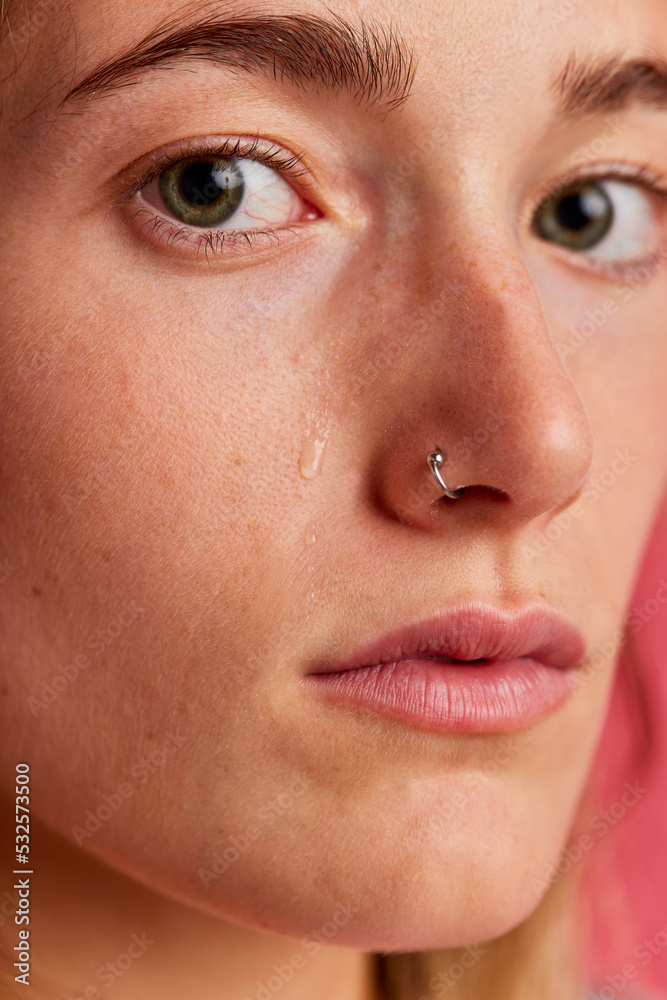 Calm freckled woman crying and looking at camera Calm freckled woman crying and looking at camera