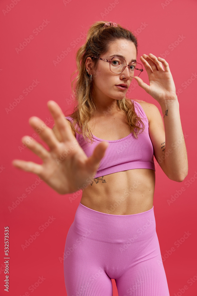 Confident young fit lady looking at camera in studio Confident young fit lady looking at camera in studio