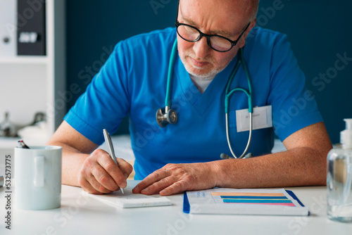 Male Doctor Writing Prescription  photo