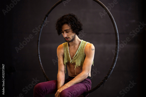 Sad artist sitting on his hoop photo