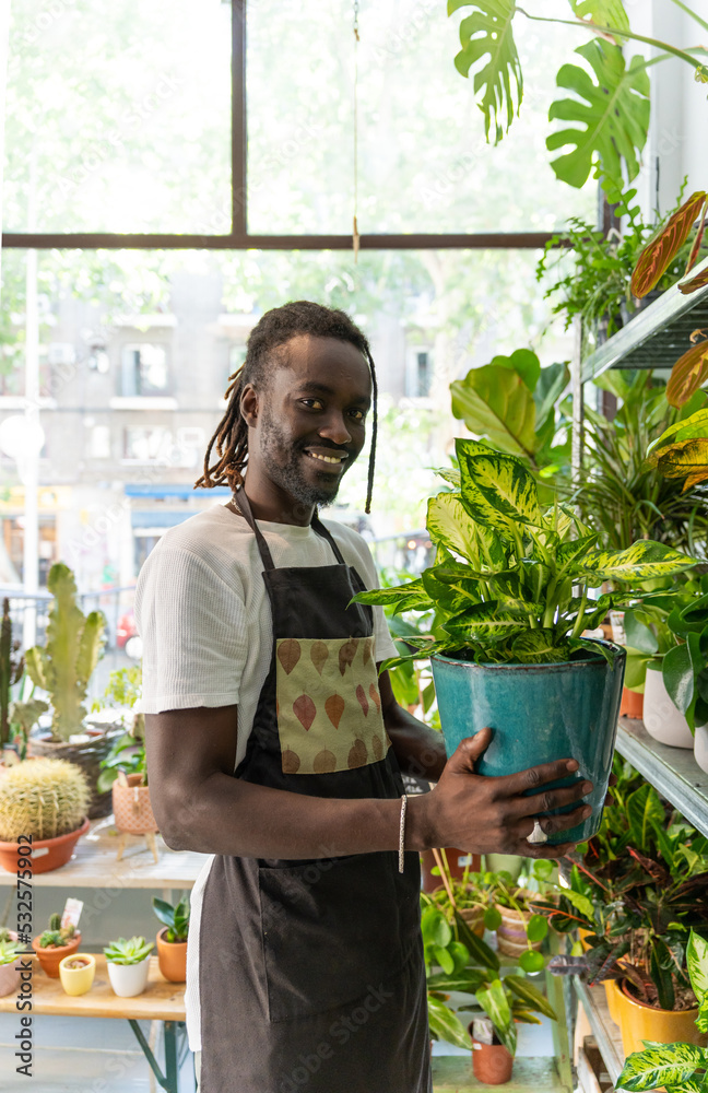 Black Man Working In A Plants Store. Black Man Working In A Plants Store.