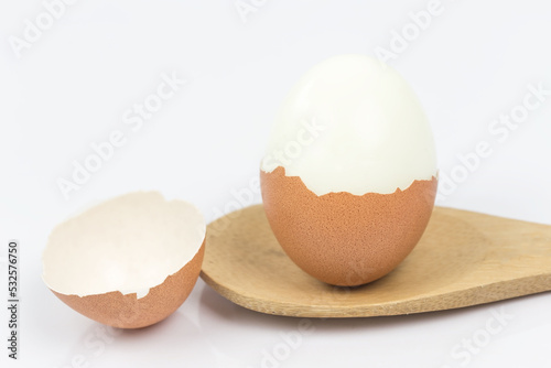 Boiled eggs placed on wooden spoon, white background. This can be used as a business card background and can be used as an advertising image. photo