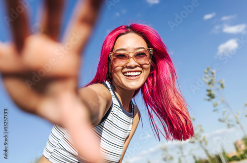 Happy chinese woman with pink hair
