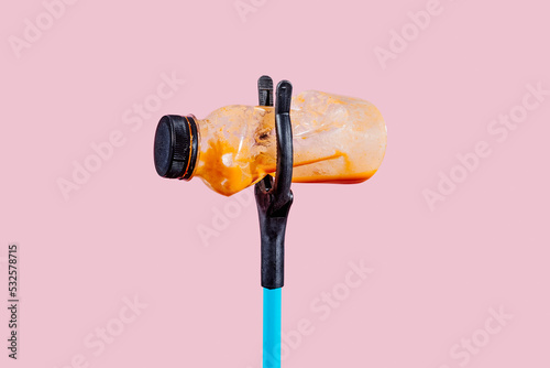 used bottle in a grabber tool
