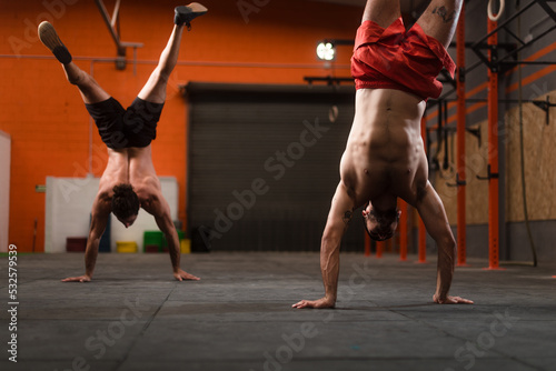 Crossfit athletes practicing handstand walk