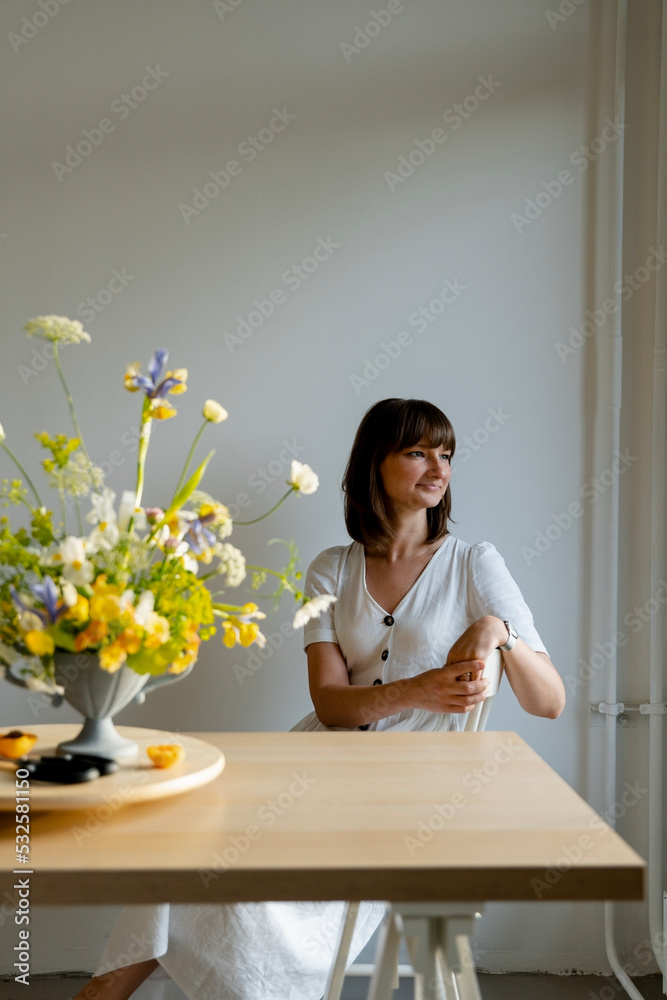 woman florist posing near self-made ikebana bouquet woman florist posing near self-made ikebana bouquet