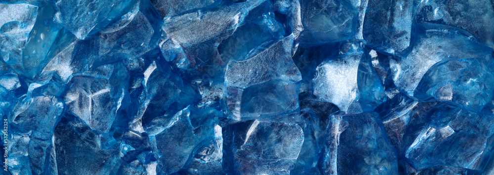 Chunks of clear glittering blue ice. Abstract cold or frozen winter background. Chunks of clear glittering blue ice. Abstract cold or frozen winter background.