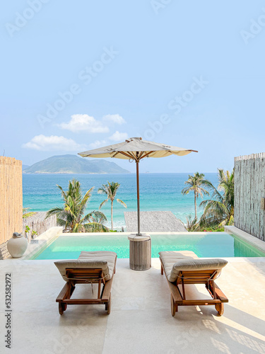 Luxury beach resort, water villa bungalow near endless pool over sea.
