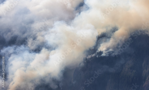 BC Forest Fire and Smoke over the mountain near Hope during a hot sunny summer day. British Columbia, Canada. Wildfire natural disaster © edb3_16