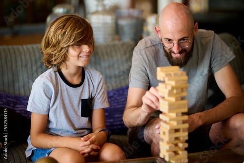 Father and son playing jenga.