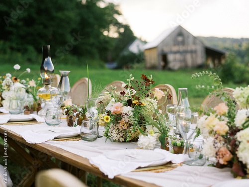 beautiful event table setting amid a green field with a view 
