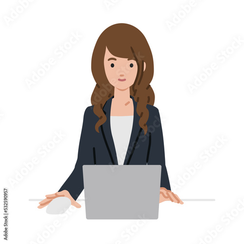 デスクで座ってPCを使っているスーツの女性