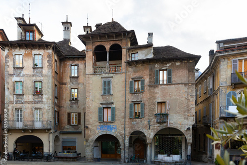 View of medieval buildings in central historical square Piazza del Mercato of Domodossola city on winter day, Italy. photo