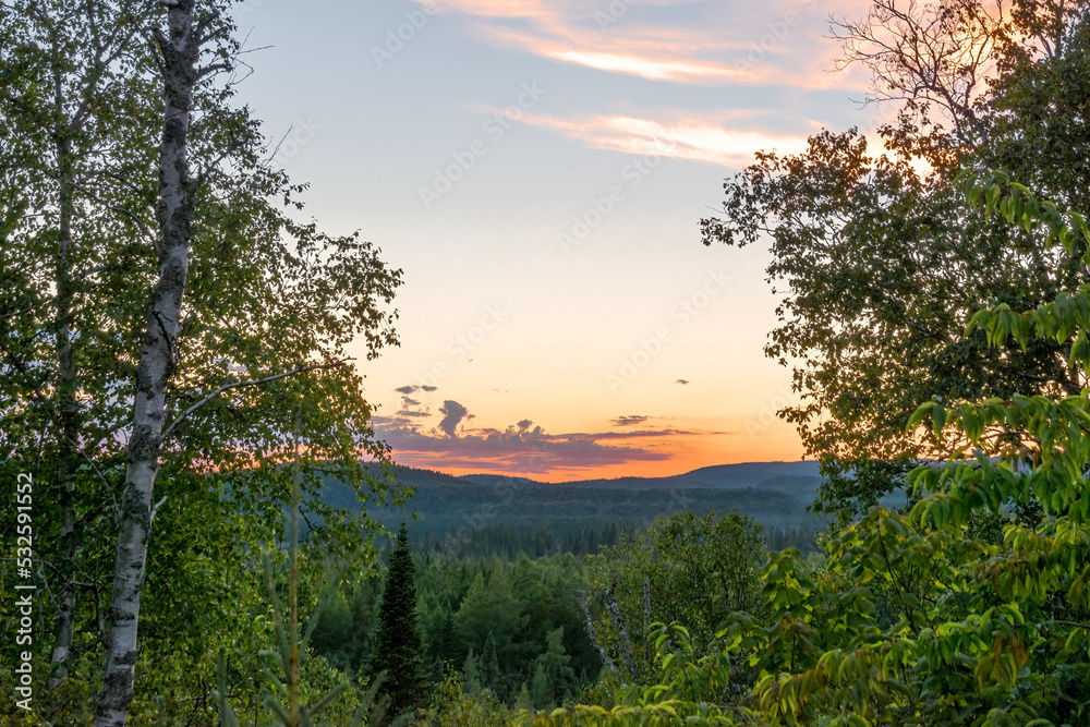 A beautiful red, orange, and magenta sunset is seen over the valley in front of the small Ontario town of Wawa. A beautiful red, orange, and magenta sunset is seen over the valley in front of the small Ontario town of Wawa.