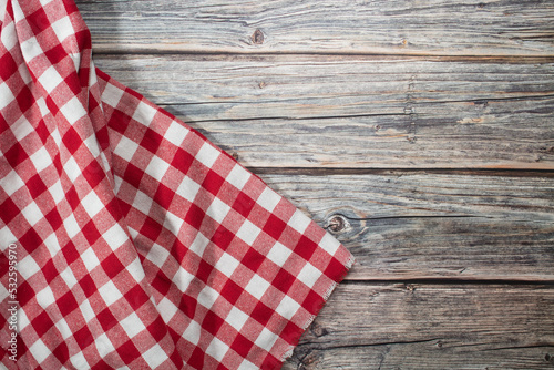 Red checkered tablecloth on wooden table