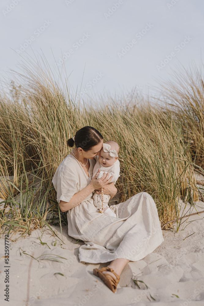 Mother with a baby girl relaxing on beach Mother with a baby girl relaxing on beach