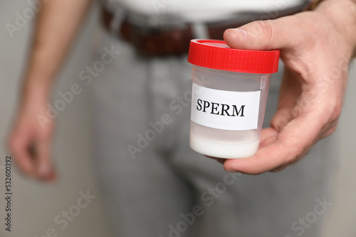 Принти на полотні Donor holding container with sperm, closeup view