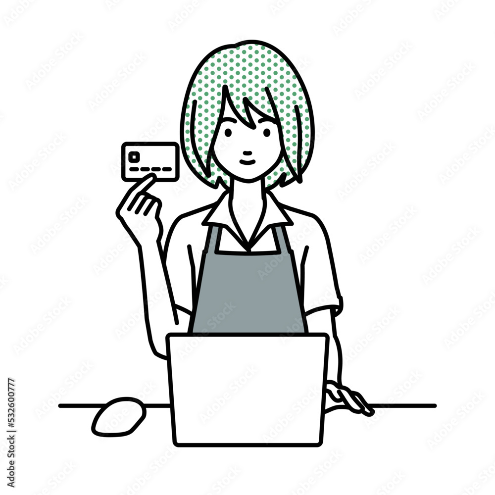 デスクで座ってPCを使いながらクレジットカードを手に持っている店員の女性 デスクで座ってPCを使いながらクレジットカードを手に持っている店員の女性