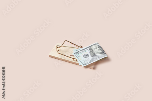 Mousetrap with US dollar bill as bait.
