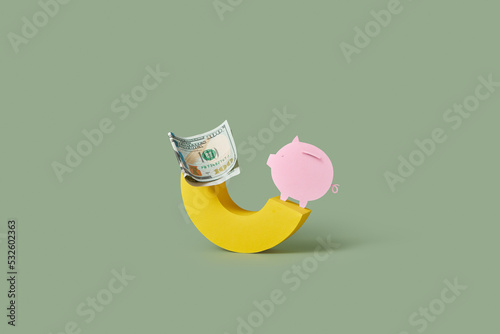 Dollar banknote and piggy bank on yellow arch. photo