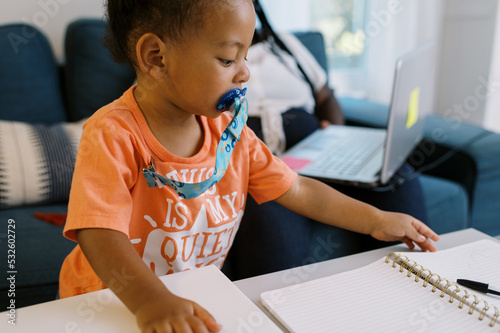 Woman working from home with a toddler