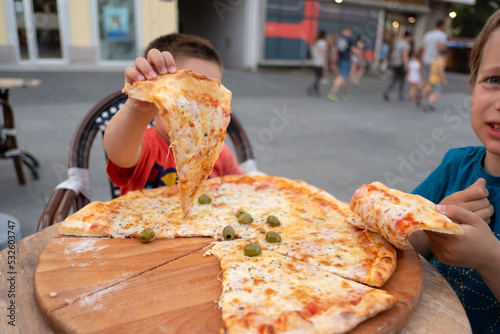 Kids having dinner outdoors photo