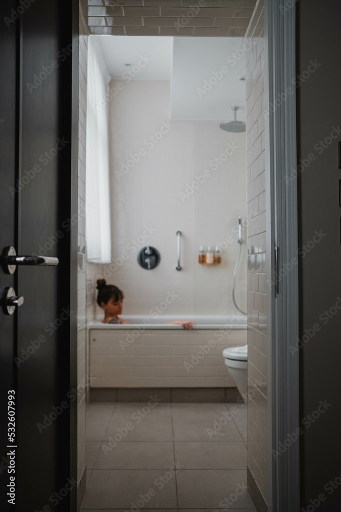 Woman in a hotel bathtub