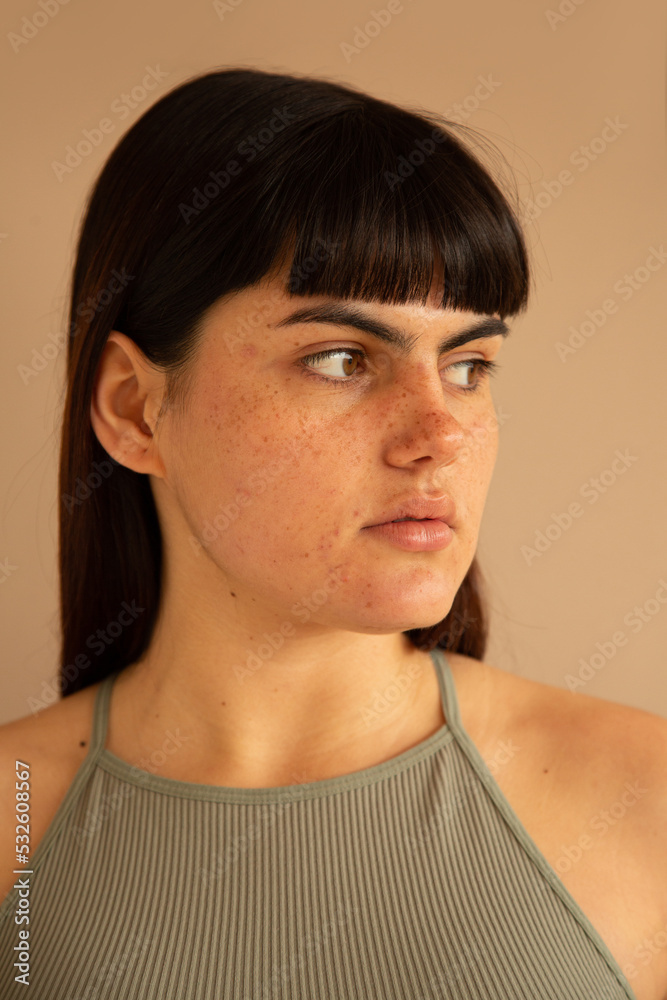 Woman with freckles looking to the side Woman with freckles looking to the side