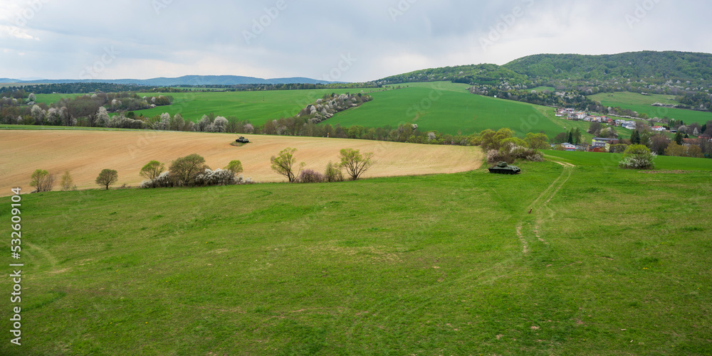 Green meadows, fields, spring forests and Russian tanks.