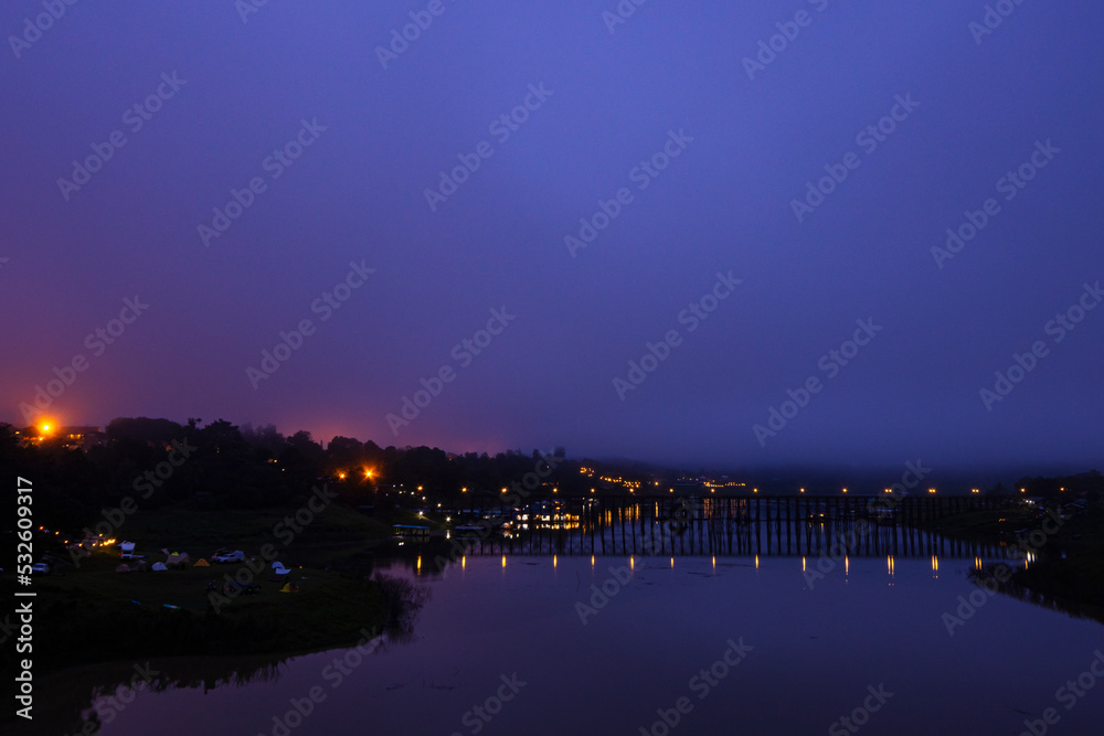 View of nature on the old wooden bridge in the morning in Thailand. View of nature on the old wooden bridge in the morning in Thailand.