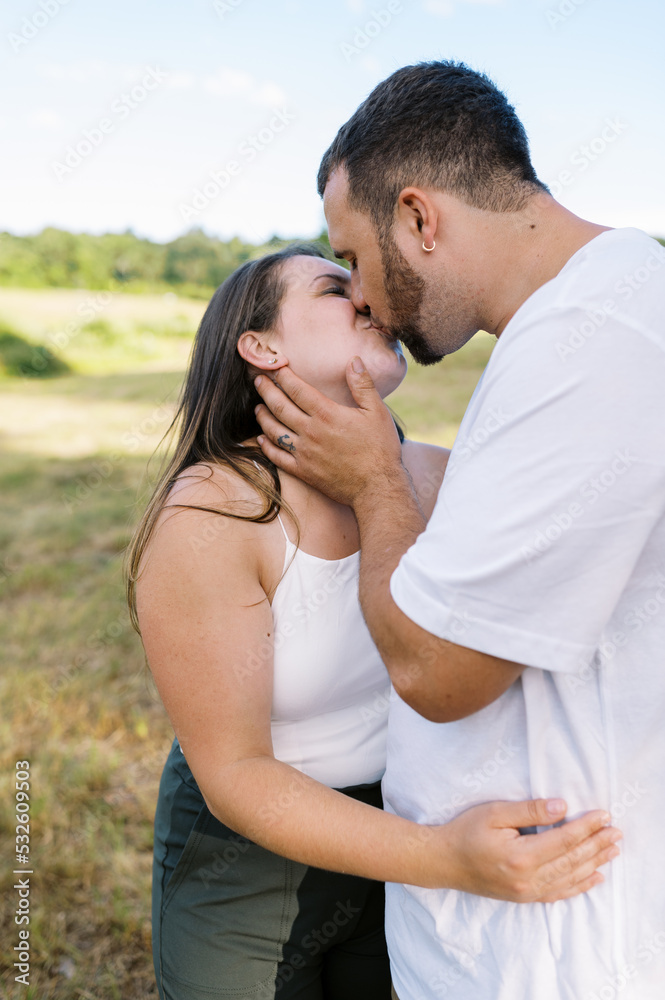 Couple holding each other in arms and kissing Couple holding each other in arms and kissing