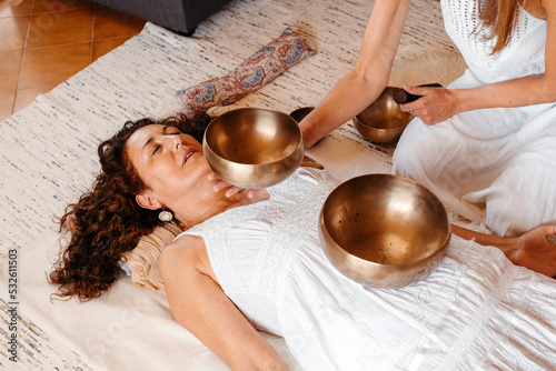 Mature woman experiencing a sound healing therapy photo