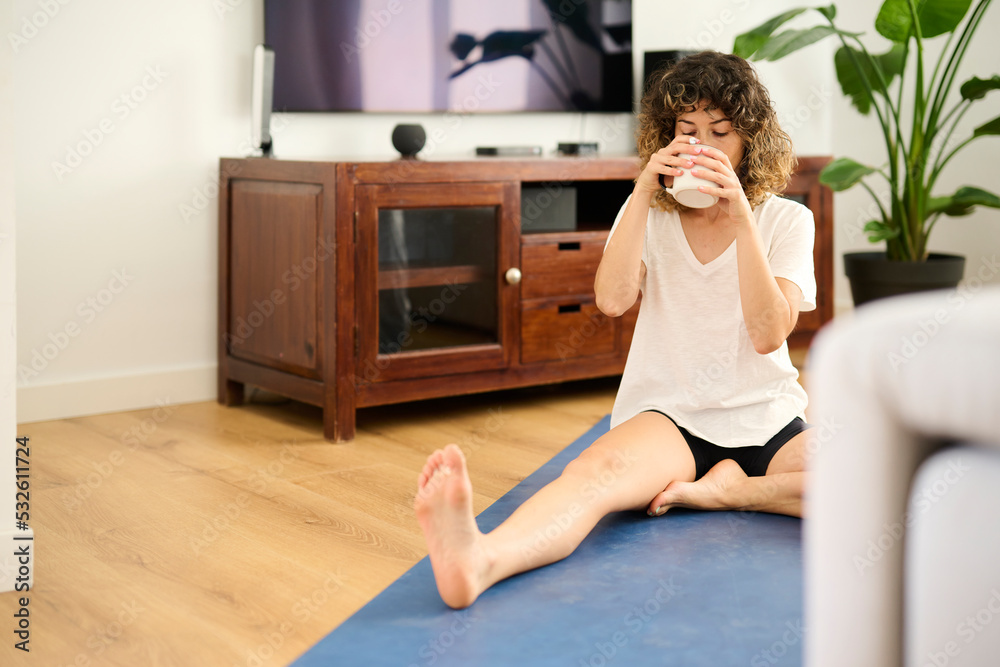 Woman drink coffee on yoga mat. Woman drink coffee on yoga mat.