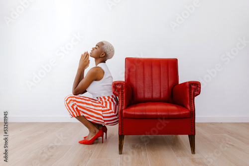 African American model praying with closed eyes photo